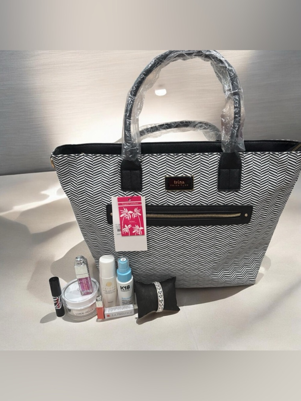 Trina Turk Black and White Chevron Tote with Front Zip Pocket Beauty Bundle